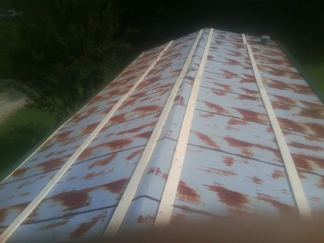 Rusted metal roof panels with new wood purlins before replacement — Storm Damage Roof Repair in Boothbay by Roofing Brothers