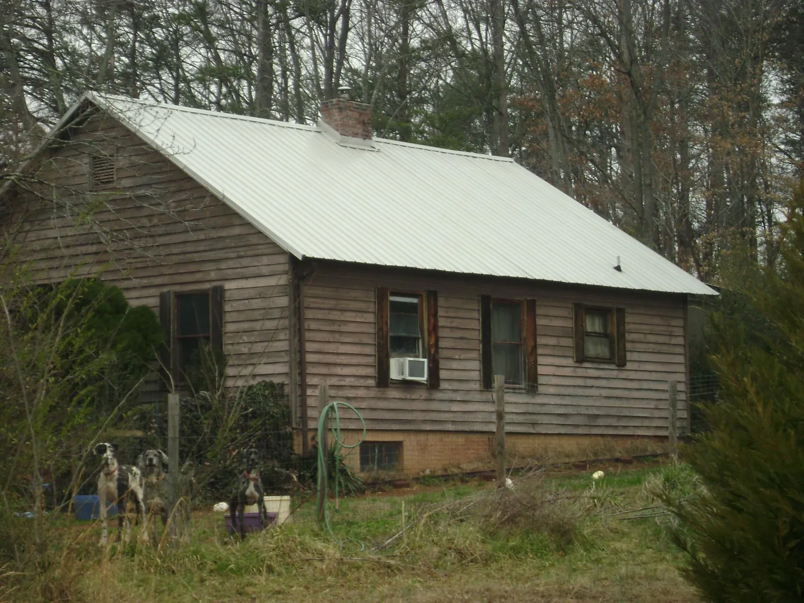 White metal roof on an old wood sided farmhouse, from a Metal Roof Installation job in Boothbay